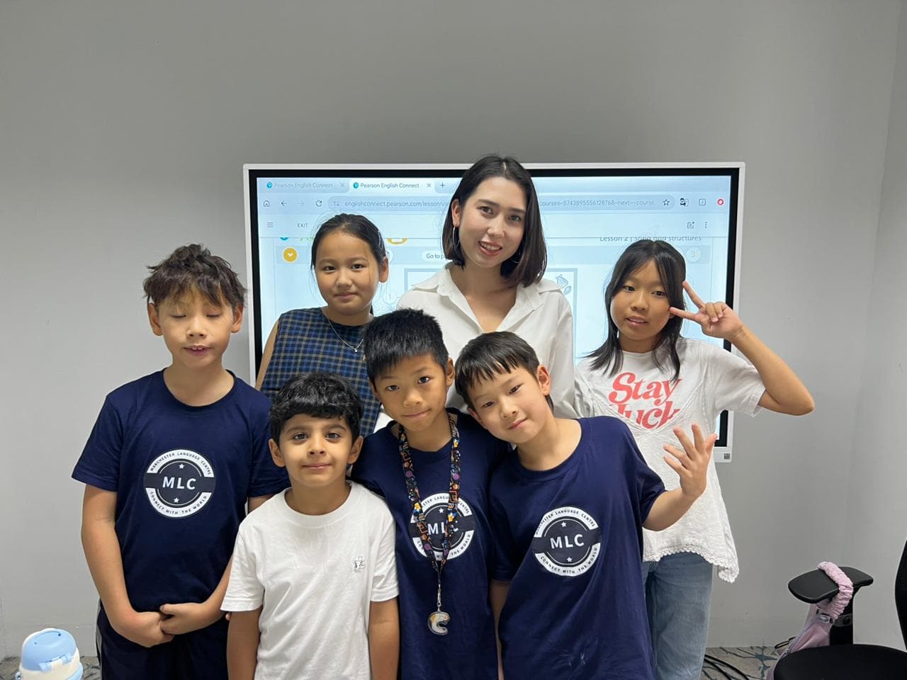 Airim with a group of students in a classroom