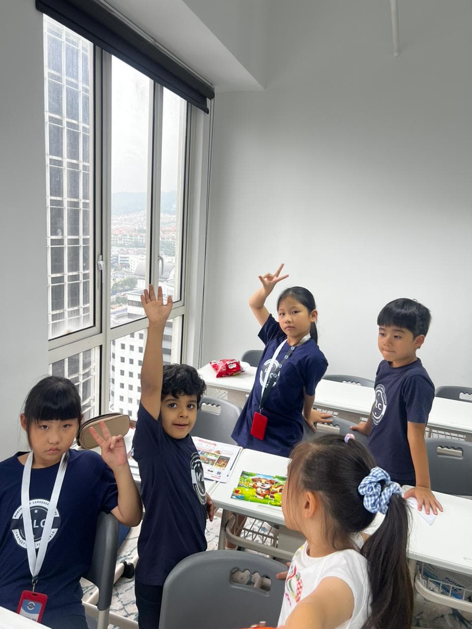 Students raising their hands to answer during a lesson